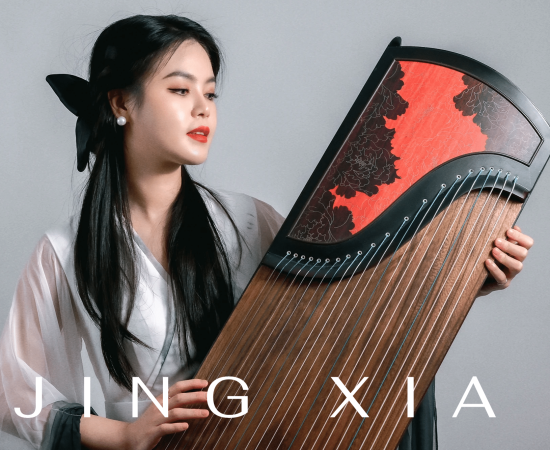 Jing Xia holding a Chinese guzheng instrument