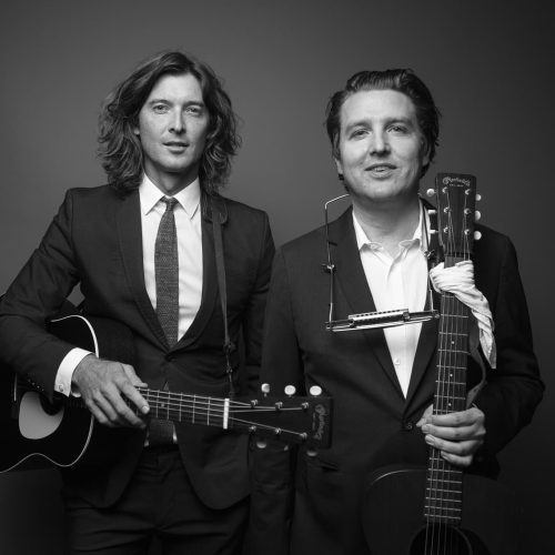 Milk Carton Kids duo black and white picture with both holding instruments.